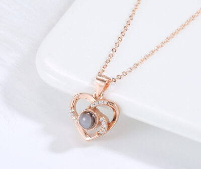 Love Link rose gold necklace featuring interlocking hearts with luminous pearl centre