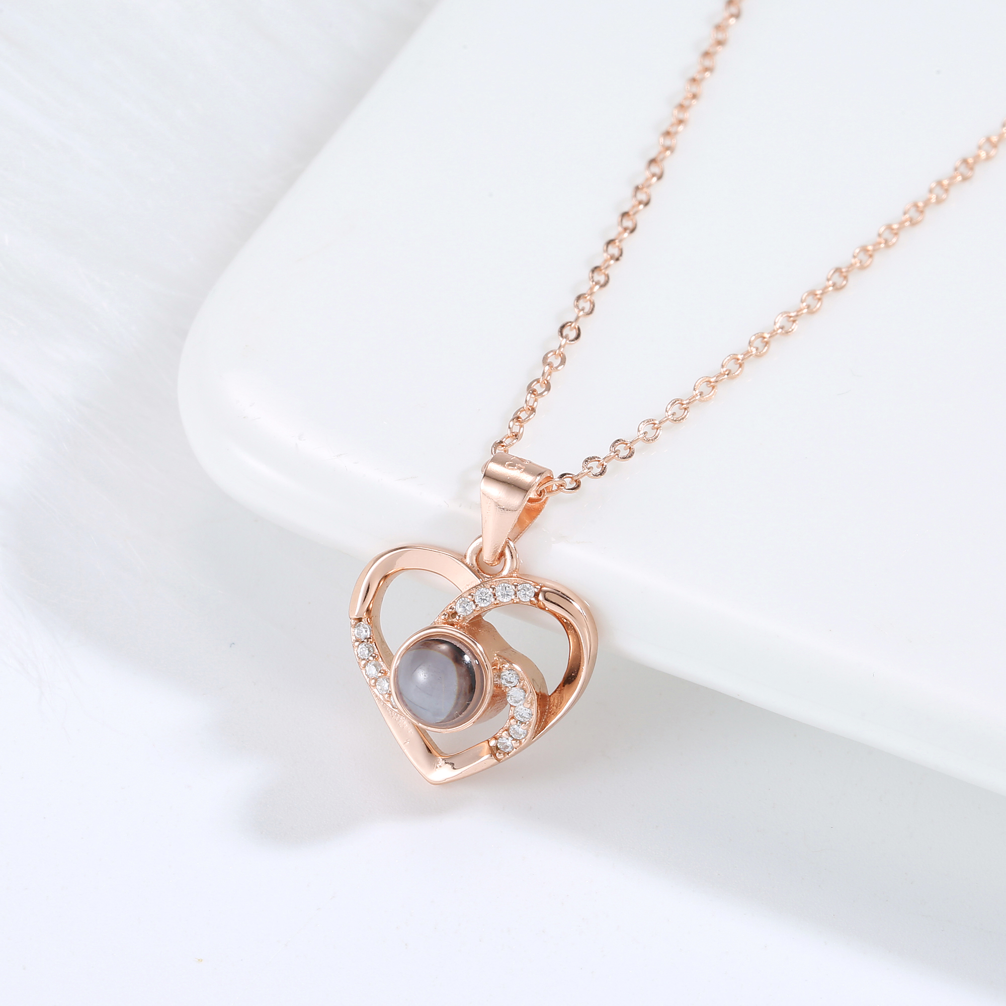 Love Link rose gold necklace featuring interlocking hearts with luminous pearl centre